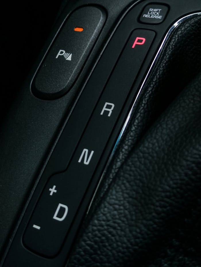 close-up-of-a-car-gear-system-5347840 Detailed view of a modern car gearshift panel, showcasing design and functionality.