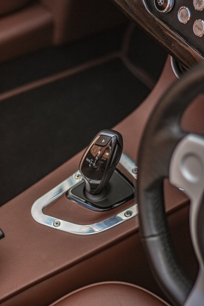 close-up-photo-of-a-gear-stick-14050048 Close-up of a luxury car interior focusing on gear stick and dashboard details.